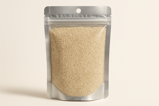  A highly realistic, front-facing product photo of a 100g hanging pouch made of aluminum with a fully transparent front from top to bottom, clearly showing the contents inside. The contents should be بهار ابيض, packed naturally with realistic textures and lighting. The aluminum is only visible on the sides and a small portion at the bottom. The image should have soft, natural shadows and plain background (hex #faf6f1). No text, labels, or branding just the pouch and its contents.