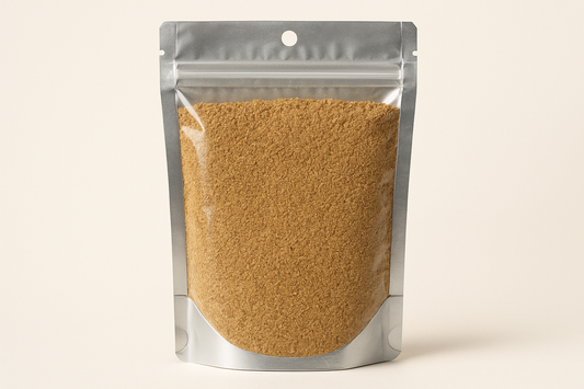  A highly realistic, front-facing product photo of a 100g hanging pouch made of aluminum with a fully transparent front from top to bottom, clearly showing the contents inside. The contents should be ground dry coriander, packed naturally with realistic textures and lighting. The aluminum is only visible on the sides and a small portion at the bottom. The image should have soft, natural shadows and plain background (hex #faf6f1). No text, labels, or branding just the pouch and its contents.