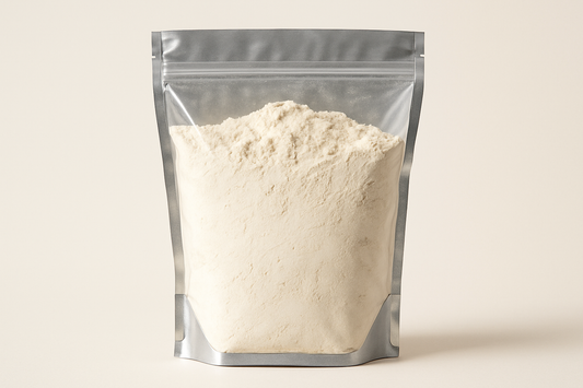 
A highly realistic, front-facing product photo of a 1kg stand-up pouch made of aluminum with a fully transparent front from top to bottom, clearly showing the contents inside. The contents should be all purpose flour, packed naturally with realistic textures and lighting. The aluminum is only visible on the sides and a small portion at the bottom. The image should have soft, natural shadows and plain background (hex #faf6f1). No text, labels, or branding—just the pouch and its contents.